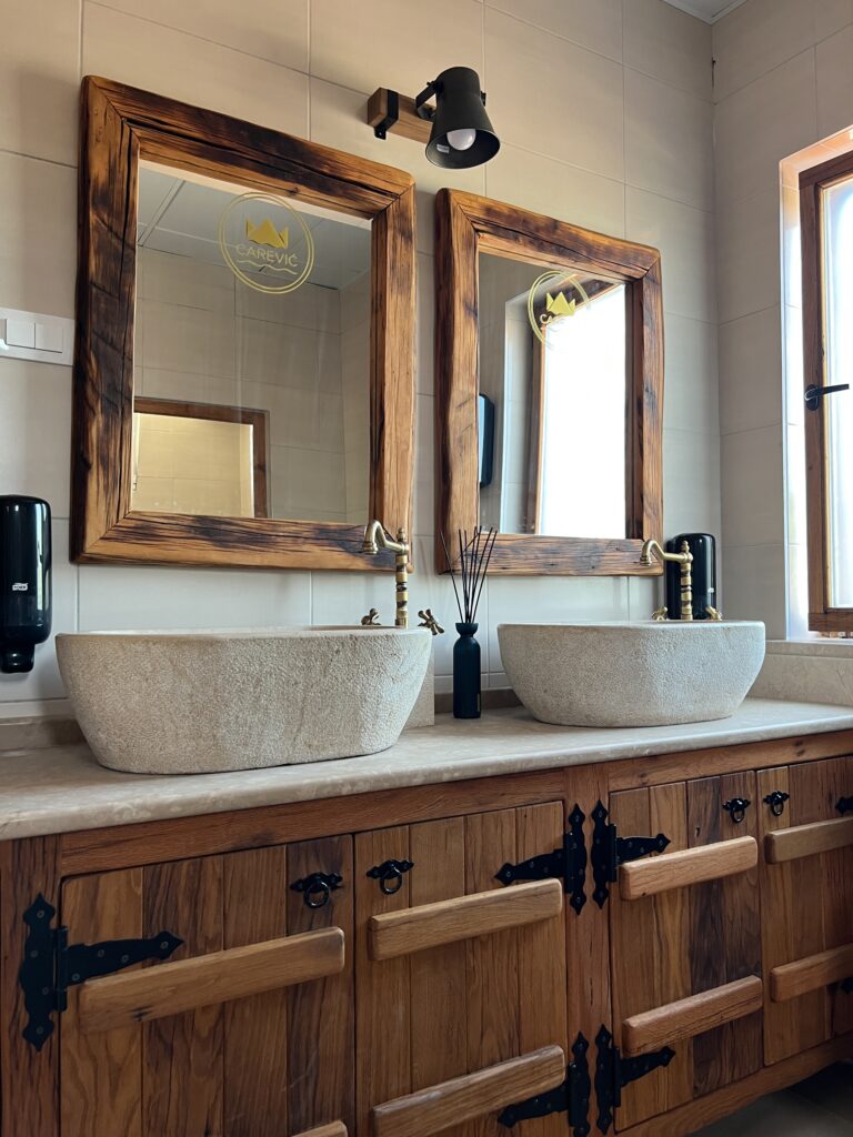 Bronze faucets over stone wash basins in the hotel bathroom. High quality photo
